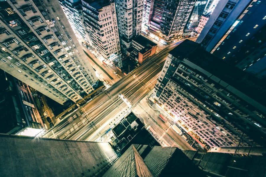 A dense city skyline of high-rise towers lit up at night